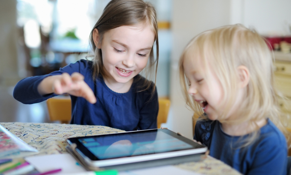 Familienservice PME Zwei Kinder vor Tablet